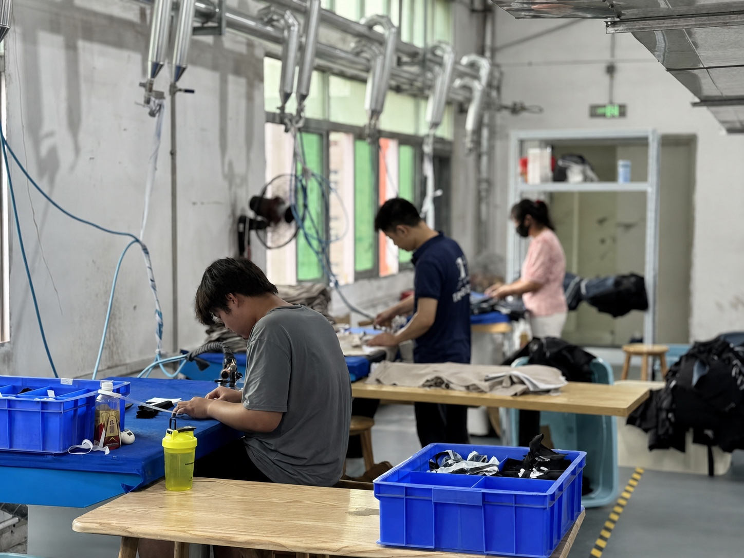 Tailored-workwear production station used to connect the buyer brief with controlled garment execution